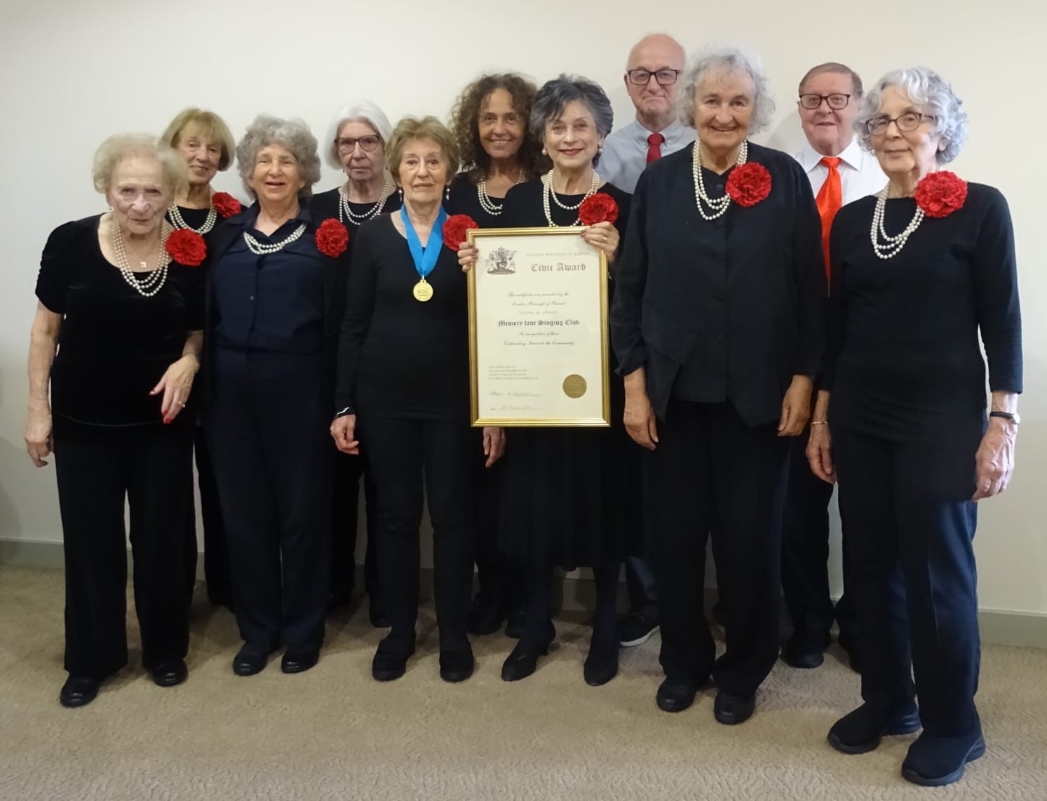 Eleven members of the choir holding the award certificate.